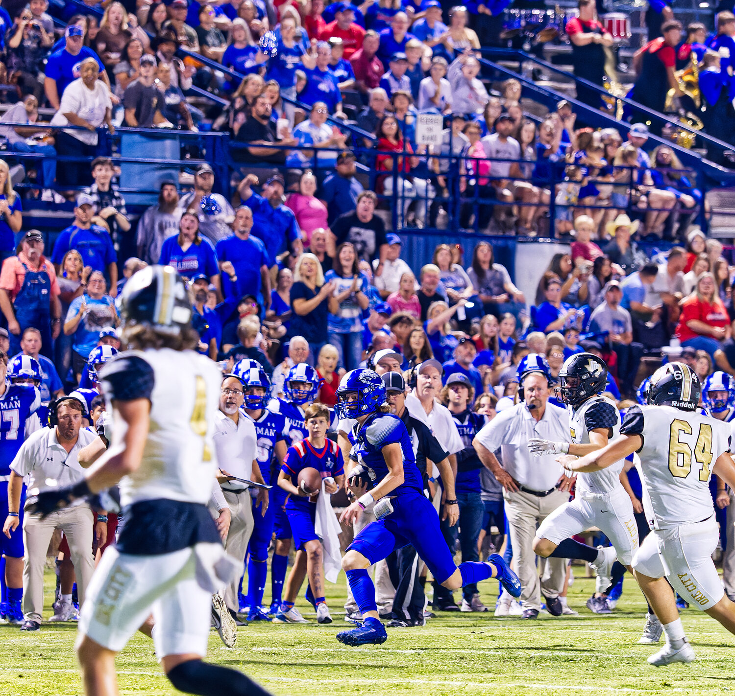 The homecoming crowd cheers as Carter Smith returns a punt, though it was called back on a blocking penalty. [view more action and buy Bulldogs prints]